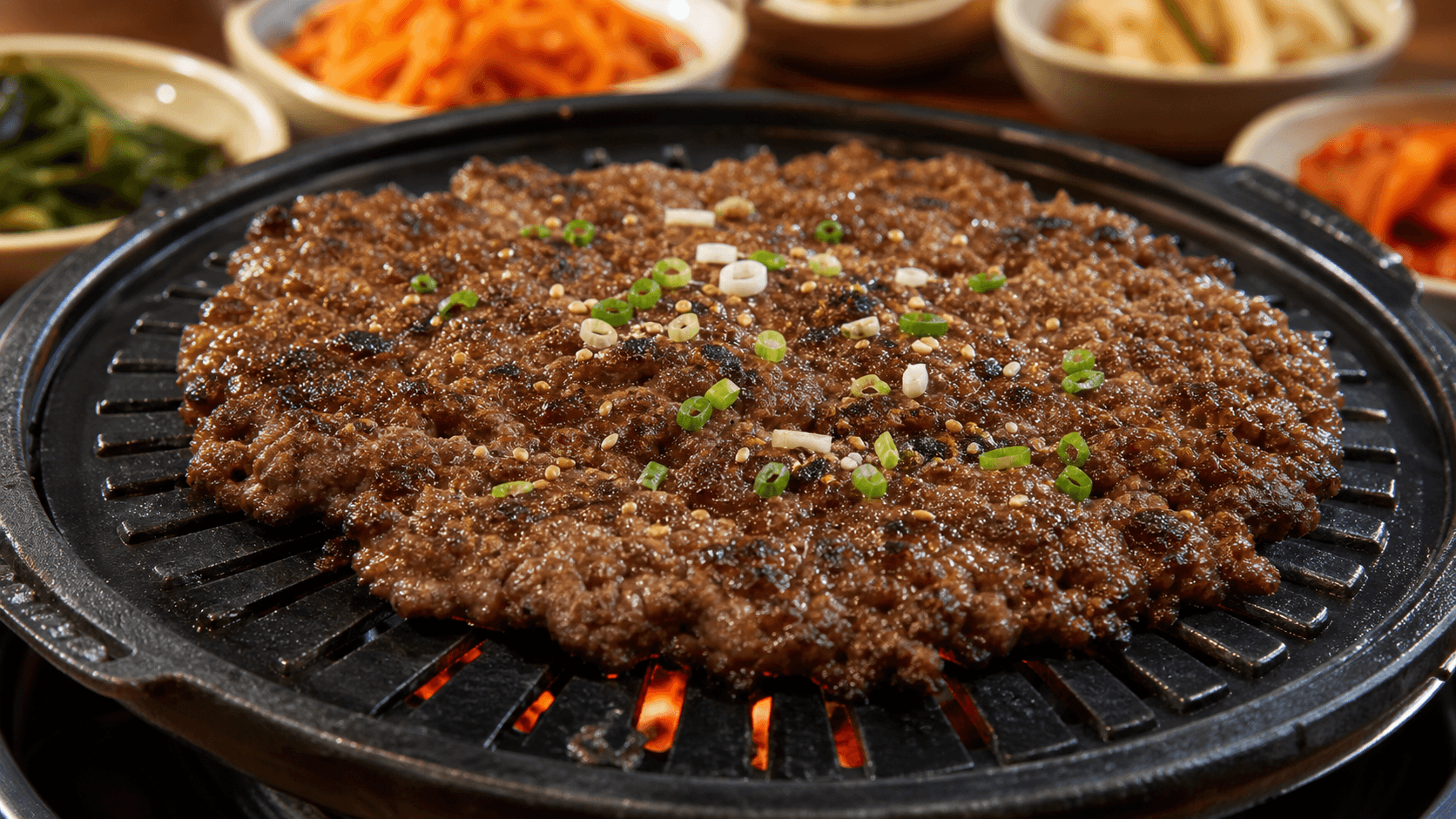 Representative Eonyang-style grilled bulgogi on a charcoal grill