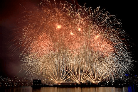 Large golden fireworks filling the night sky above Seoul