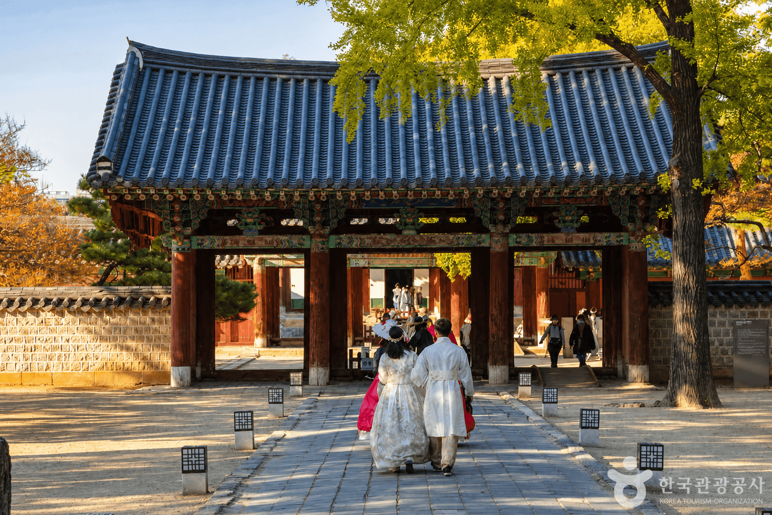 Visitors walking toward a traditional gate at Gyeonggijeon Shrine in Jeonju